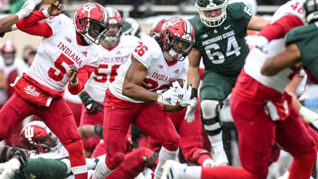 Indiana's Josh Henderson runs for a gain against Michigan State during overtime on Saturday, Nov. 19, 2022, at Spartan Stadium in East Lansing.