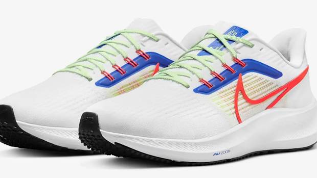 View of white, red, and blue Nike shoes.