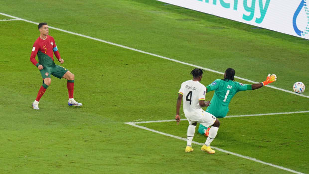 Portugal's Cristiano Ronaldo pictured (left) shooting past Ghana goalkeeper Lawrence Ati-Zigi but his goal was disallowed for an earlier foul