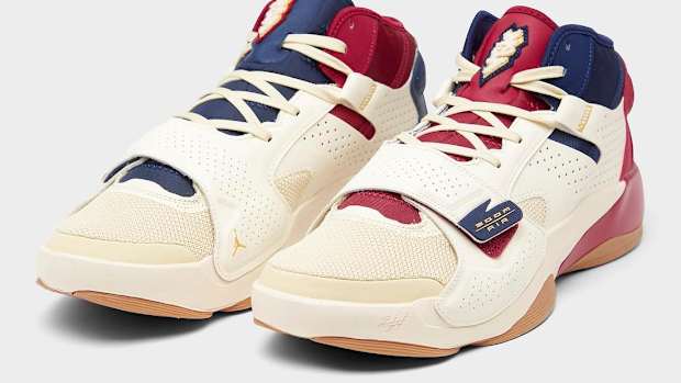 View of red, navy, and tan Jordan Zion shoes.