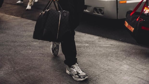 View of Caleb Williams' grey Asics sneakers before a USC Trojans game.