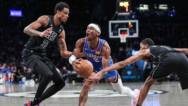 Oklahoma City Thunder guard Shai Gilgeous-Alexander (2) drives against Brooklyn Nets center Nic Claxton (33