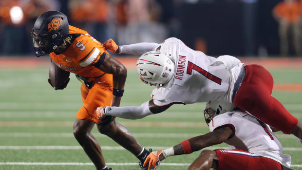 Sep 16, 2023; Stillwater, Oklahoma, USA; Oklahoma State Cowboys wide receiver Jaden Bray (5) tries to get past South Alabama Jaguars cornerback Marquise Robinson (7) and South Alabama Jaguars safety Jalen Jordan (1) during an NCAA football game between Oklahoma State and South Alabama at Boone Pickens Stadium. South Alabama won 33-7. Mandatory Credit: Bryan Terry-USA TODAY Sports
