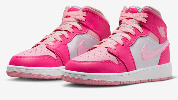 Side view of pink and white Air Jordan shoes.