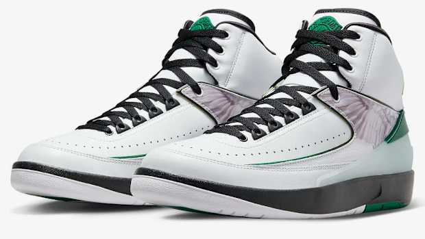 Side view of white, green, and black Air Jordan shoes.