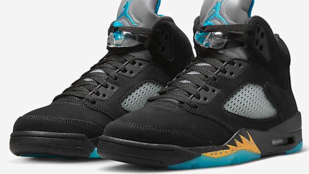 View of black and aqua Air Jordan shoes.