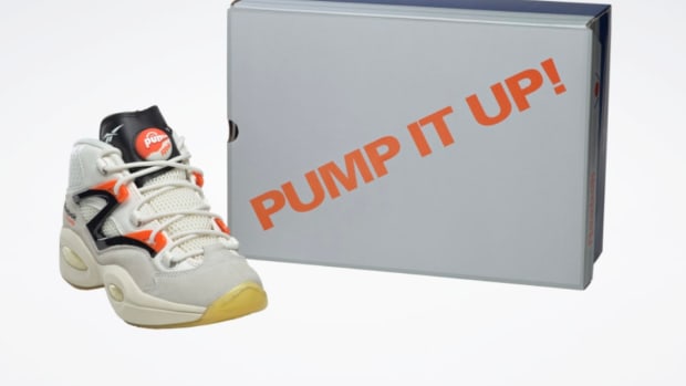 View of white and black Reebok shoe and box.