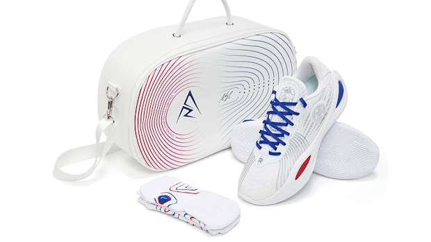 Side view of Austin Reaves' white, blue, and red sneakers.