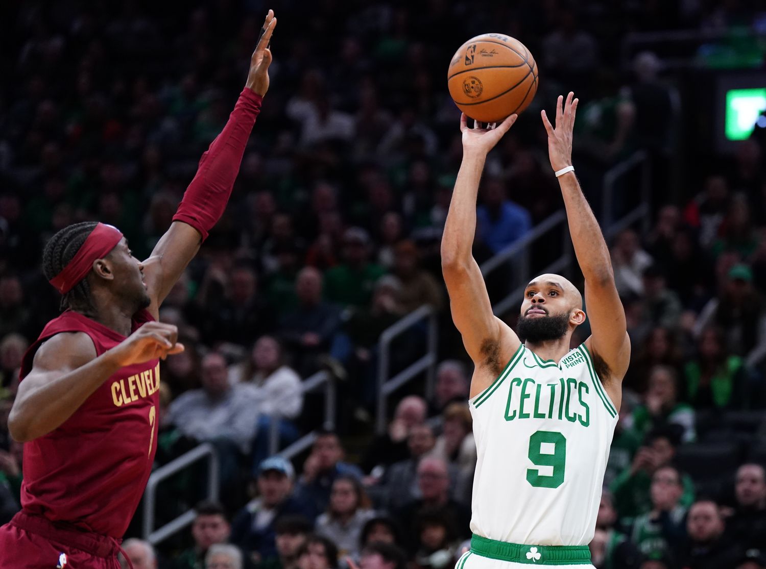 Dec 12, 2023; Boston, Massachusetts, USA; Boston Celtics guard Derrick White (9) shoots for three points against Cleveland Cavaliers guard Caris LeVert (3) in the second half at TD Garden.