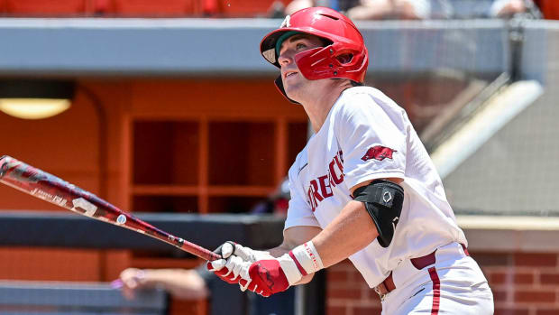 Arkansas' Cayden Wallace watches a home run fly over the left-field fence in the Razorbacks' 7-1 win over Grand Canyon in the first game of the NCAA Regional in Stillwater, Okla.