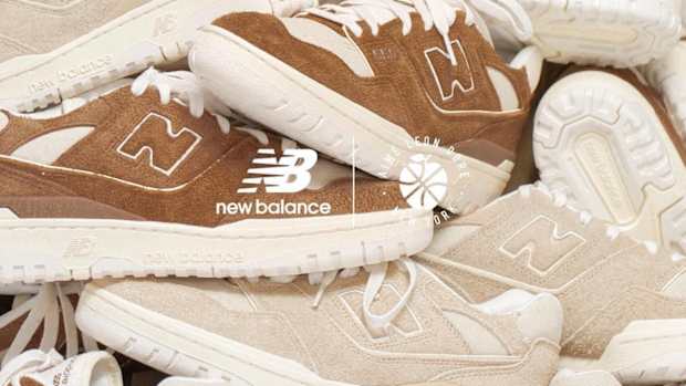 Pile of brown and cream New Balance sneakers stacked together.