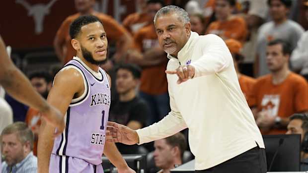 Kansas State Wildcats head coach Jerome Tang talks with guard Markquis Nowell