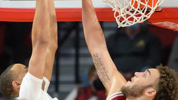 Race Thompson tries to block a dunk.