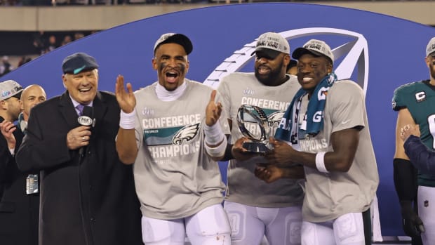 Eagles from left to right, Jalen Hurts, Fletcher Cox, and A.J. Brown celebrate winning NFC title