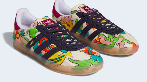 Side view of navy and green adidas sneakers.