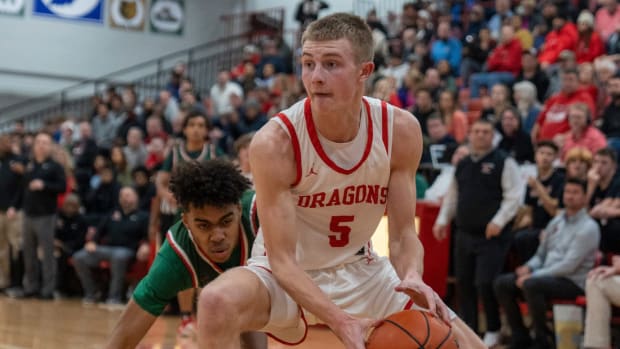 New Palestine High School's Ian Stephens (5) dribbles past a Lawrence North High School defender, at NPHS, Monday, Jan. 30, 2023, during a game won by LNHS, 59-58.