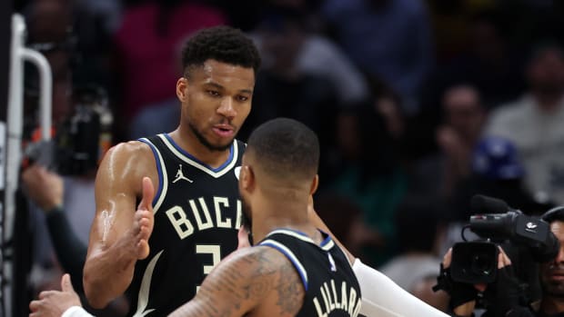 Milwaukee Bucks forward Giannis Antetokounmpo (34) celebrates with guard Damian Lillard (0) 
