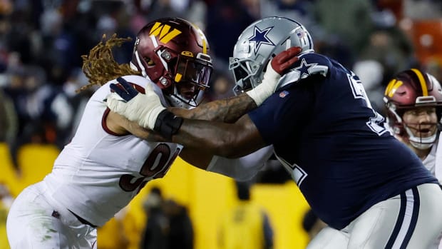 Defensive end Chase Young (left) goes up against a Dallas Cowboys offensive lineman (right).