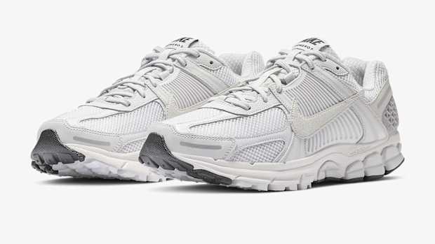 Side view of white and grey Nike sneakers.