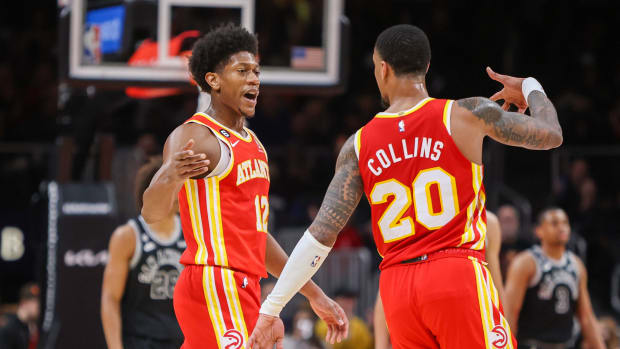 Hawks forwards De'Andre Hunter and John Collins celebrate after a made shot.
