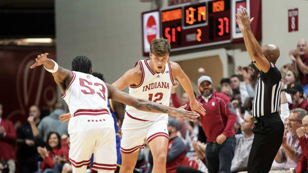 Indiana Hoosiers forward Miller Kopp (12) high-fives Indiana Hoosiers guard Tamar Bates (53) after making a three-pointer during the second half at Simon Skjodt Assembly Hall.