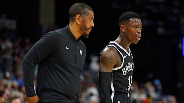 Brooklyn Nets head coach Kevin Ollie (left) talks with Brooklyn Nets guard Dennis Schroder (17)