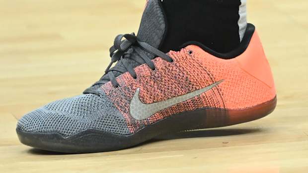 View of orange and grey Nike Kobe shoe.