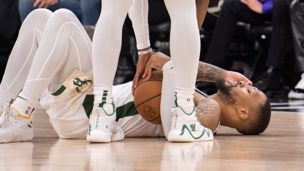 Milwaukee Bucks guard Damian Lillard (0) lays on the floor