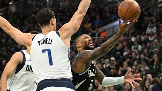 Milwaukee Bucks guard Damian Lillard (0) puts up a shot against Dallas Mavericks center Dwight Powell (7)
