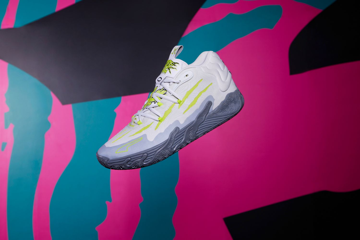 Side view of LaMelo Ball's grey and green PUMA basketball shoe.