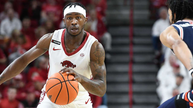 Arkansas guard Davonte Davis brings the ball up the court against Auburn.