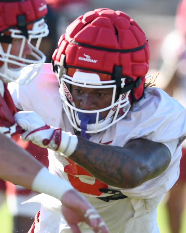 Razorbacks Ty Washington blocking during a preseason scrimmage last year.