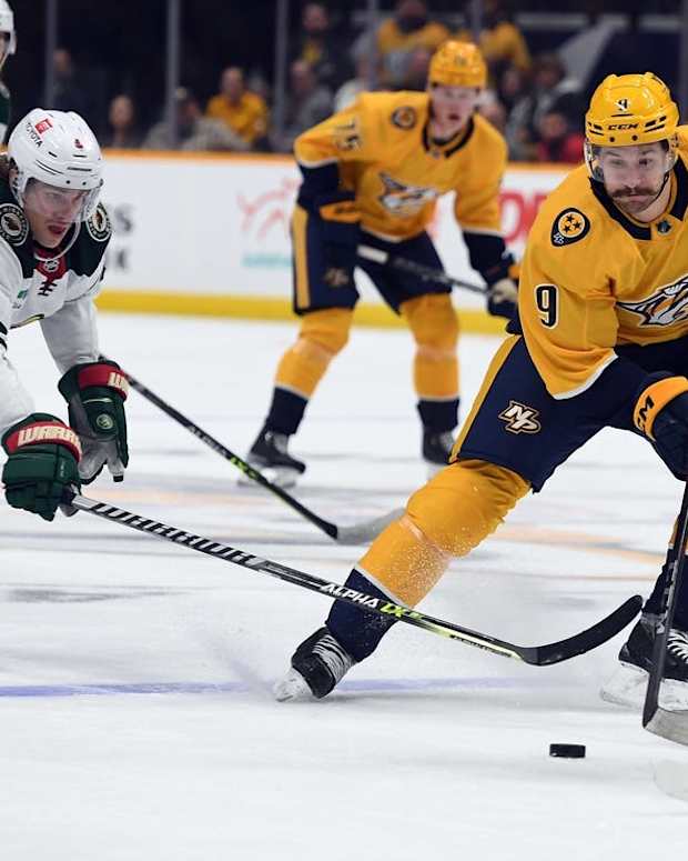 Nov 15, 2022; Nashville, Tennessee, USA; Nashville Predators left wing Filip Forsberg (9) skates with the puck against Minnesota Wild left wing Kirill Kaprizov (97) during the first period at Bridgestone Arena. Mandatory Credit: Christopher Hanewinckel-USA TODAY Sports