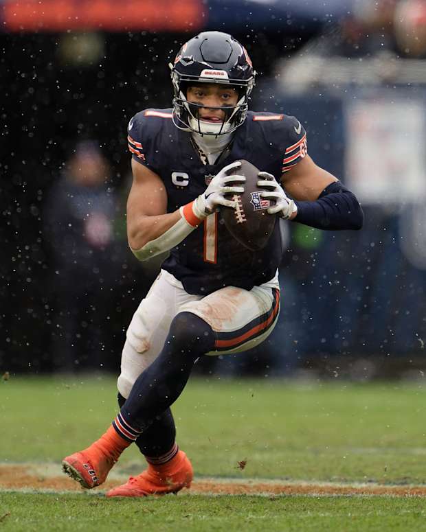 Dec 31, 2023; Chicago, Illinois, USA; Chicago Bears quarterback Justin Fields (1) runs with the ball against the Atlanta Falcons at Soldier Field.