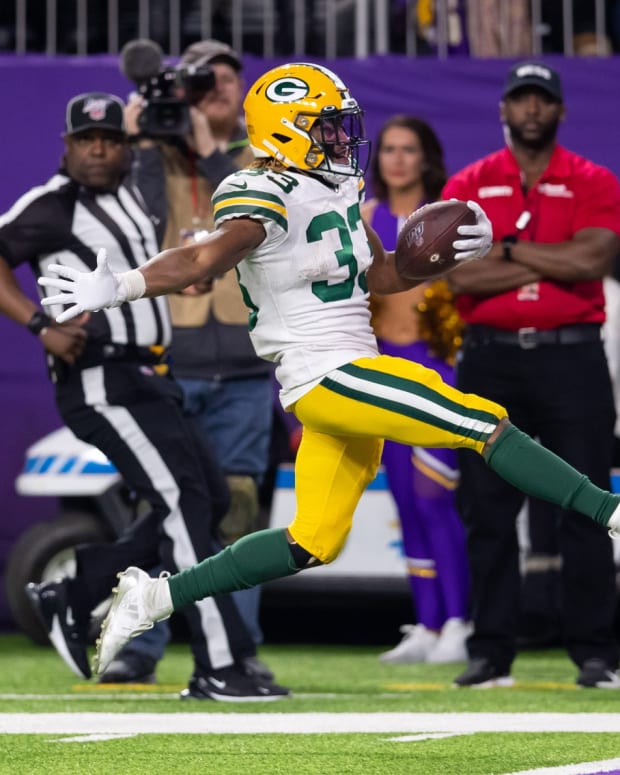 Dec 23, 2019; Minneapolis, Minnesota, USA; Green Bay Packers running back Aaron Jones (33) rushes for a touchdown in the fourth quarter against Minnesota Vikings at U.S. Bank Stadium.