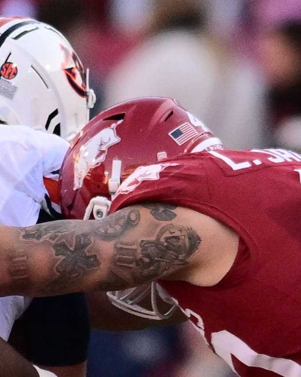 Razorbacks defensive lineman Landon Jackson delivers a hit on Auburn quarterback Payton Thorne