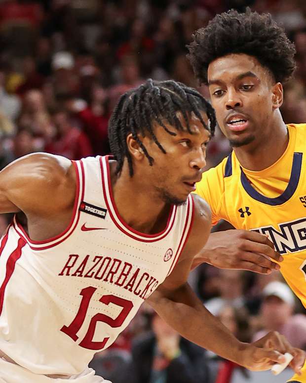Razorbacks' Tramon Mark drives against UNC-Greensboro's Donovan Atwell