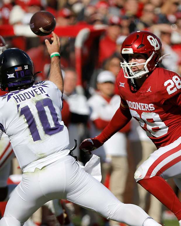 Oklahoma Sooners linebacker Danny Stutsman (28) runs after TCU Horned Frogs quarterback Josh Hoover (10) as he throws a pass during a college football game between the University of Oklahoma Sooners (OU) and the TCU Horned Frogs at Gaylord Family-Oklahoma Memorial Stadium in Norman, Okla., Friday, Nov. 24, 2023. Oklahoma won 69-45.