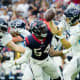 Jan 9, 2022; Houston, TX, USA; Tennessee Titans quarterback Ryan Tannehill (17) is pressured by Houston Texans defensive end Jacob Martin (54) during the fourth quarter at NRG Stadium.