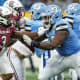 Dec 30, 2021; Charlotte, NC, USA; South Carolina Gamecocks defensive end Jordan Burch (3) tries to evade North Carolina Tar Heels offensive lineman Joshua Ezeudu (75) during the second quarter at Bank of America Stadium.