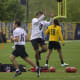 Calvin Austin goes up for a ball during drills.