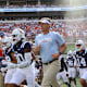 Lane Kiffin running out with Ole Miss Football.