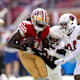 San Francisco 49ers wide receiver Brandon Aiyuk (11) holds onto the ball after making a catch next to Arizona Cardinals cornerback Marco Wilson (20) and safety Jalen Thompson (34) in the second quarter at Levi's Stadium.