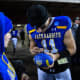 SDSU's quarterback Mark Gronowski (11) signs a football for a kid after winning the FCS semifinals on Friday, Dec. 15, 2023 at Dana J. Dykhouse in Brookings.