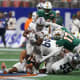 Dec 16, 2023; Atlanta, GA, USA; Howard Bison running back Eden James (5) is tackled by Florida A&M Rattlers defensive lineman Dakar Edwards (17) in the second half at Mercedes-Benz Stadium.