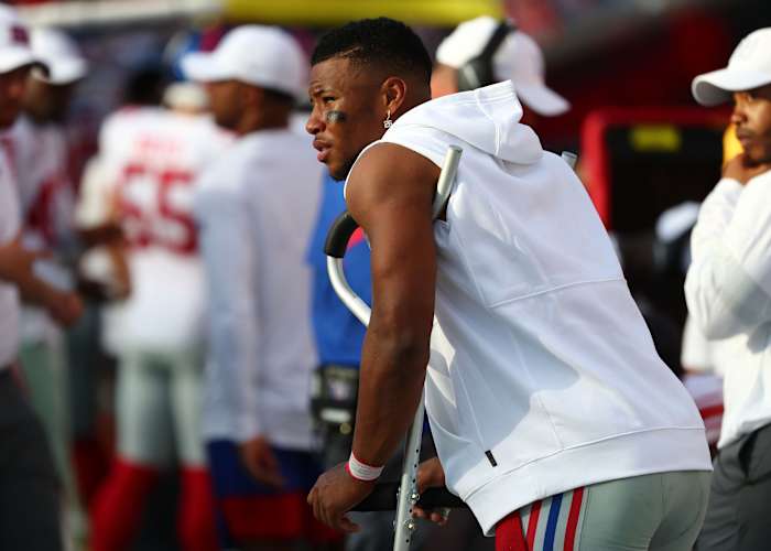 Sep 22, 2019; Tampa, FL, USA;New York Giants running back Saquon Barkley (26) stands on the sideline with crutches during the second half against the Tampa Bay Buccaneers at Raymond James Stadium.