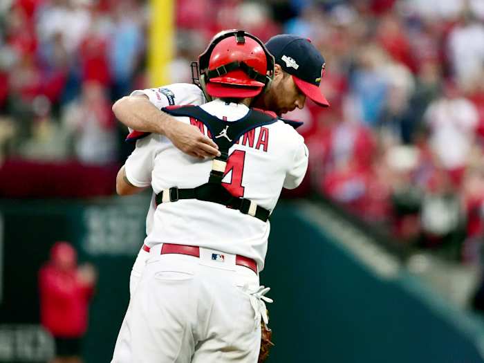 Oct 6, 2019; St. Louis, MO, USA; St. Louis Cardinals pitcher Adam Wainwright (50) hugs catcher Yadier Molina (4) after he Wainwright is relieved in the eighth inning in game three of the 2019 NLDS playoff baseball series against the Atlanta Braves at Busch Stadium. Mandatory Credit: Jeff Curry-USA TODAY Sports