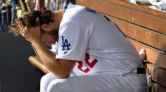 Oct 9, 2019; Los Angeles, CA, USA; Los Angeles Dodgers starting pitcher Clayton Kershaw (22) reacts in the dugout during the eighth inning in game five of the 2019 NLDS playoff baseball series against the Washington Nationals at Dodger Stadium. Mandatory Credit: Jayne Kamin-Oncea-USA TODAY Sports