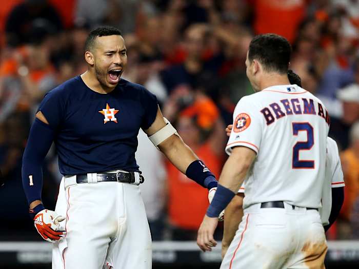 Oct 13, 2019; Houston, TX, USA; Houston Astros shortstop Carlos Correa (1) celebrates with third baseman Alex Bregman (2) after hitting a walk off solo home run off of New York Yankees starting pitcher J.A. Happ (not pictured) during the eleventh inning in game two of the 2019 ALCS playoff baseball series at Minute Maid Park. Mandatory Credit: Thomas B. Shea-USA TODAY Sports
