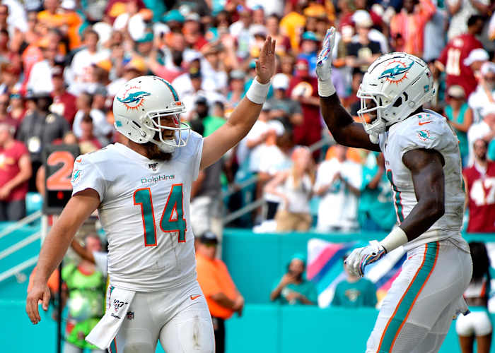 Oct 13, 2019; Miami Gardens, FL, USA; Miami Dolphins quarterback Ryan Fitzpatrick (left) greets wide receiver DeVante Parker (right) on a touchdown catch against the Washington Redskins during the second half at Hard Rock Stadium. Mandatory Credit: Steve Mitchell-USA TODAY Sports
